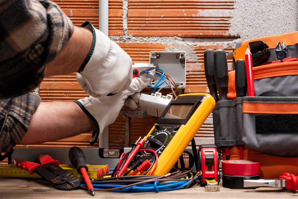 electrician fixing an electrical outlet