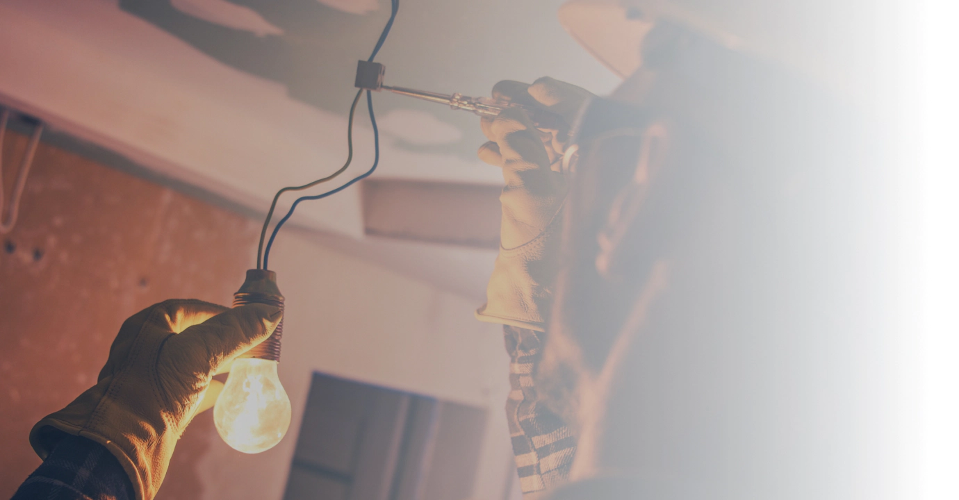 man installing light bulb